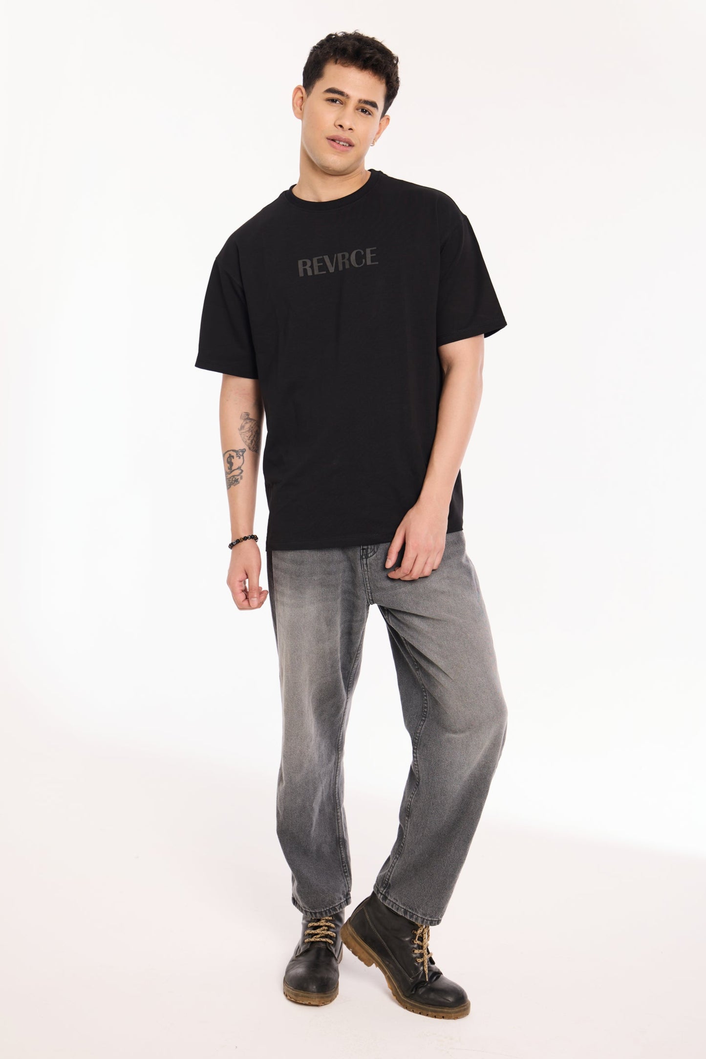 Back view of model wearing Midnight Mark Solid Black Tee by Revrce, oversized streetwear t-shirt