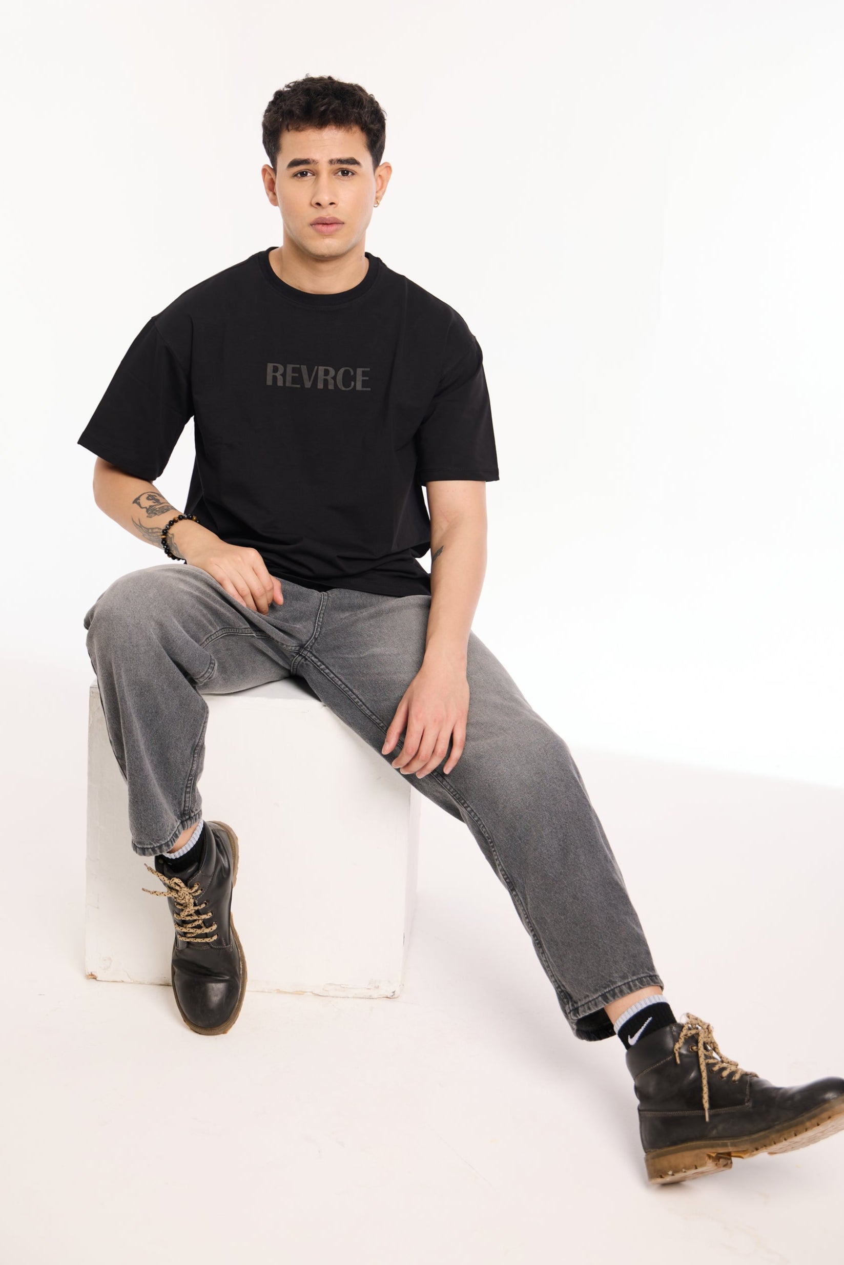 Flat lay of Midnight Mark Solid Black Tee by Revrce, oversized streetwear t-shirt in detail