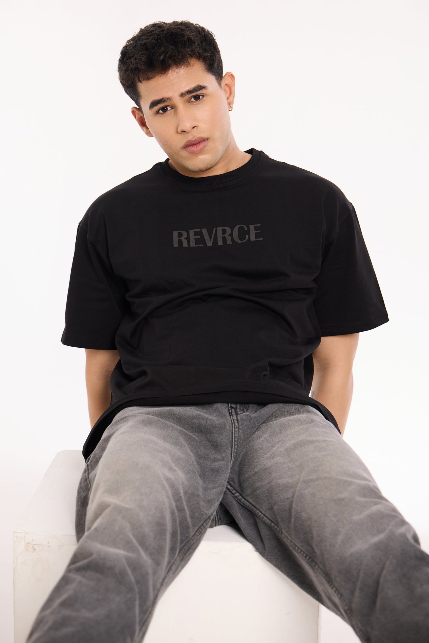 Close-up of Midnight Mark Solid Black Tee by Revrce showing puff print or fabric texture