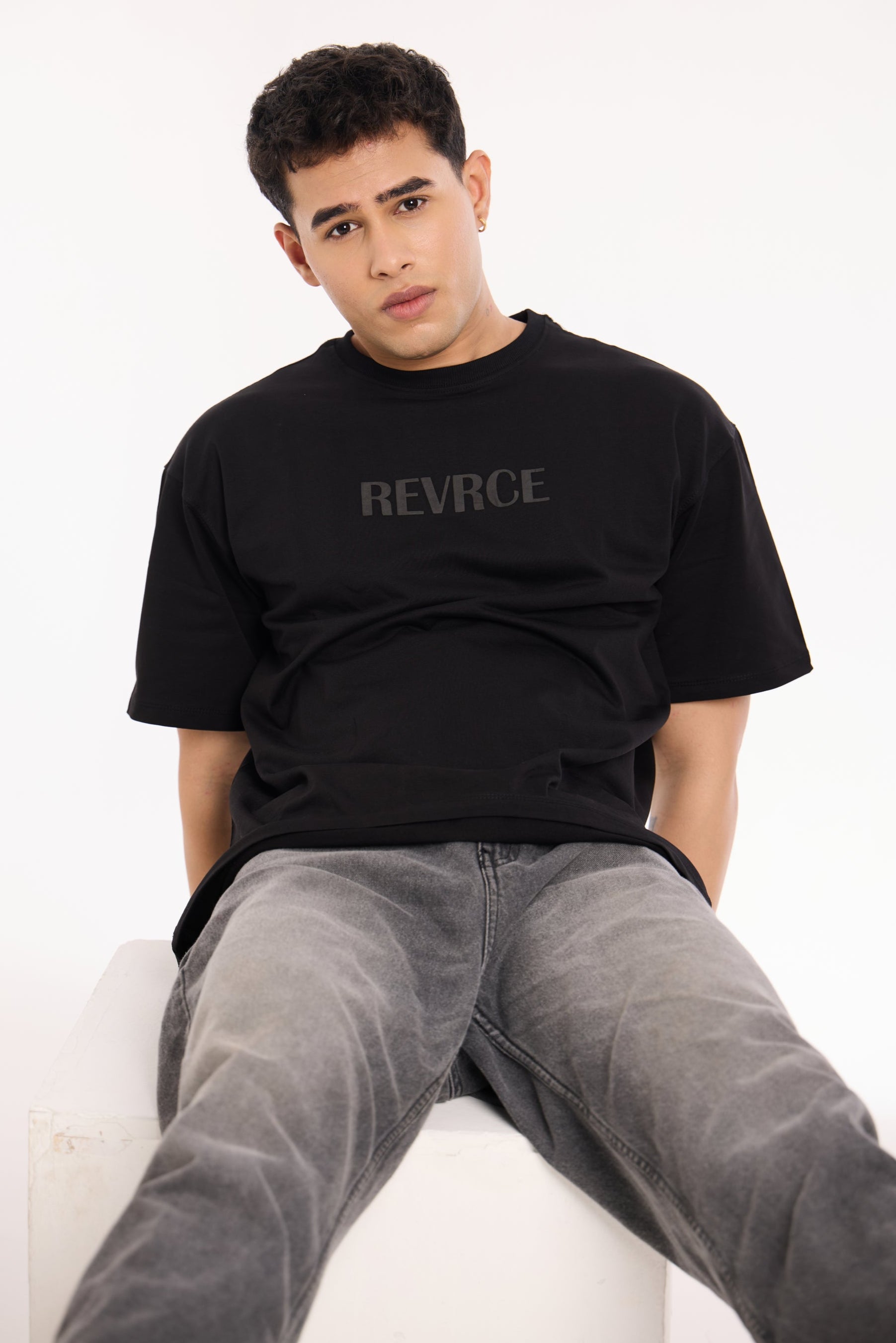 Close-up of Midnight Mark Solid Black Tee by Revrce showing puff print or fabric texture