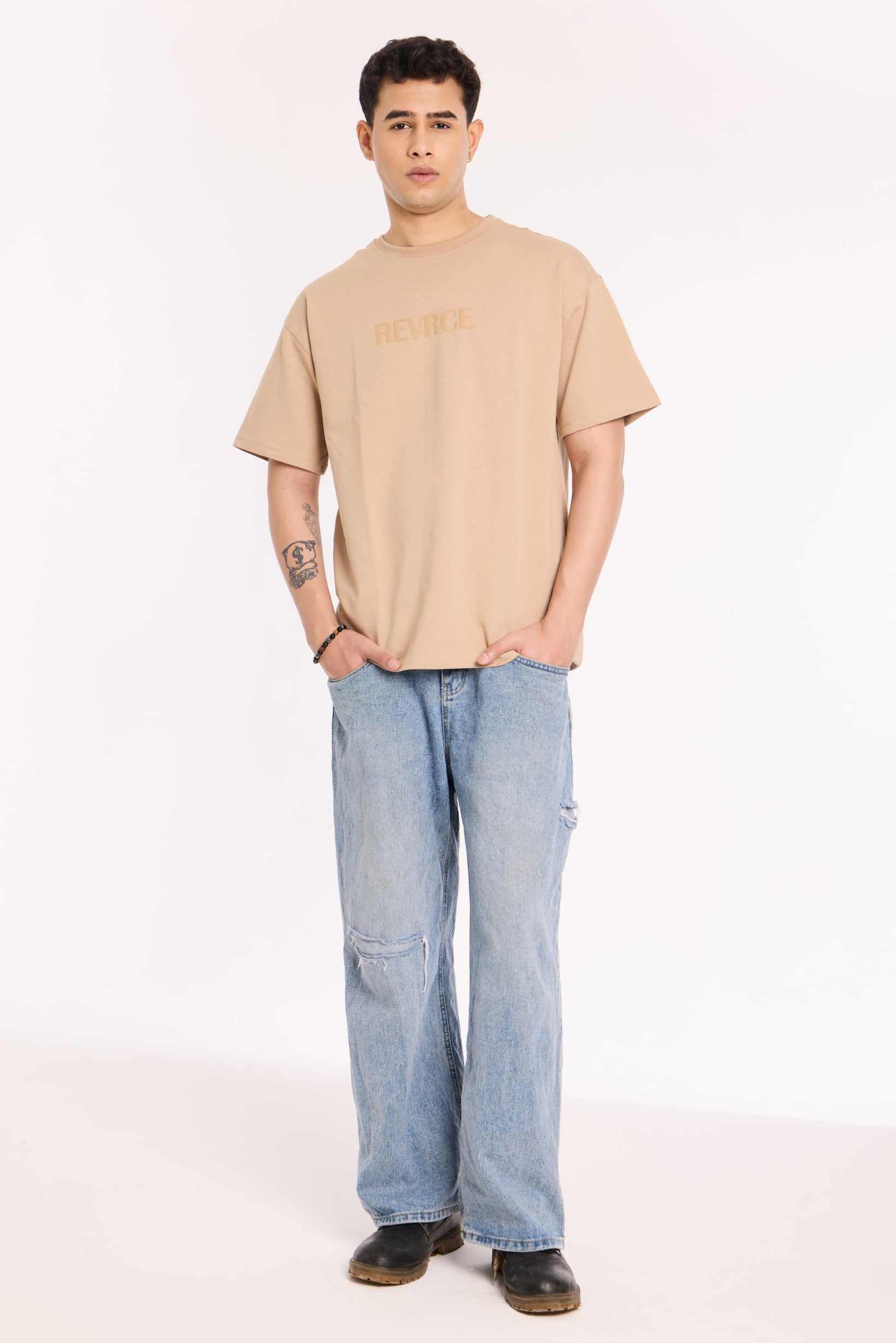 Back view of model wearing Sandy Silence T Shirt by Revrce, oversized streetwear t-shirt