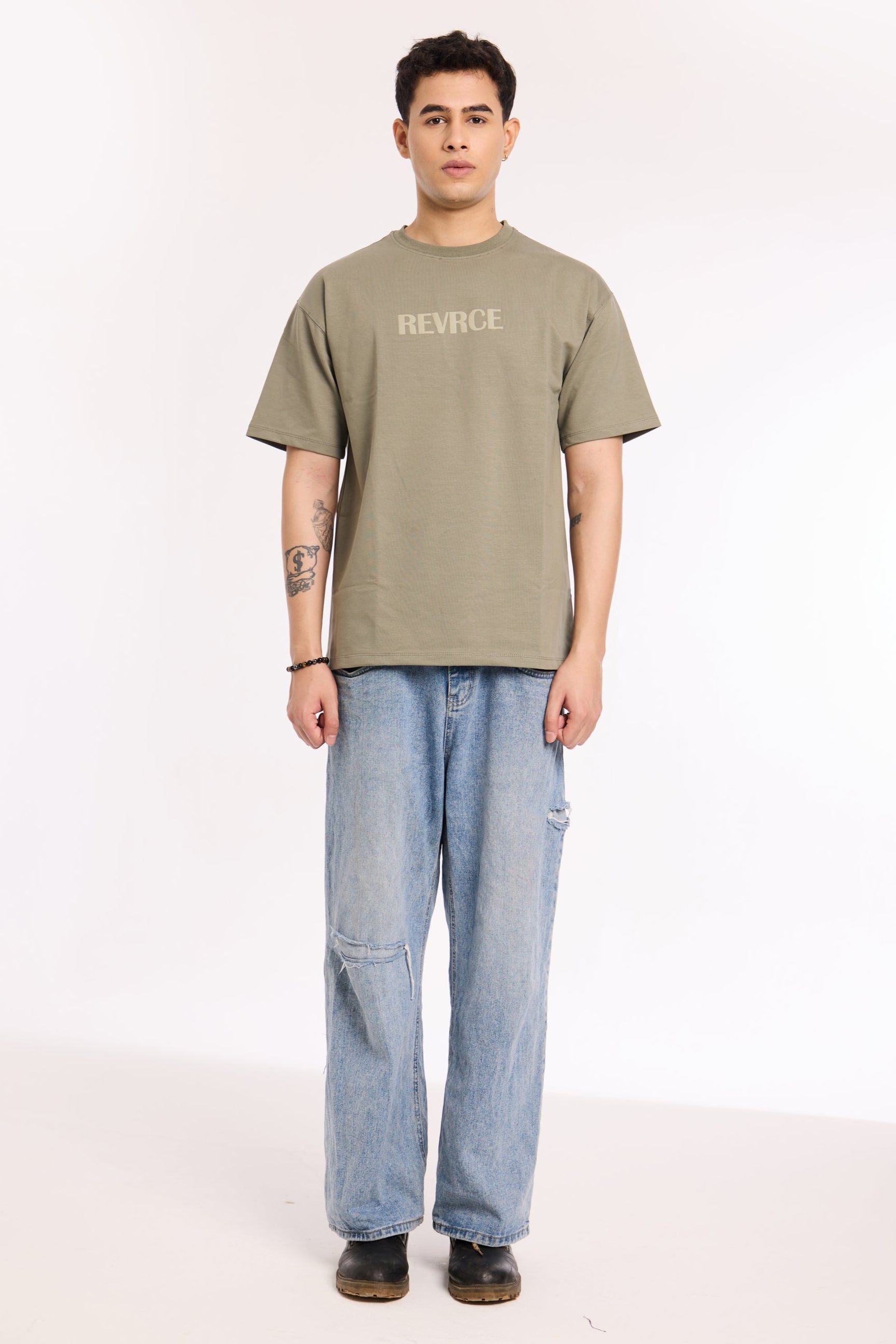 Back view of model wearing Cement by Revrce, oversized streetwear t-shirt