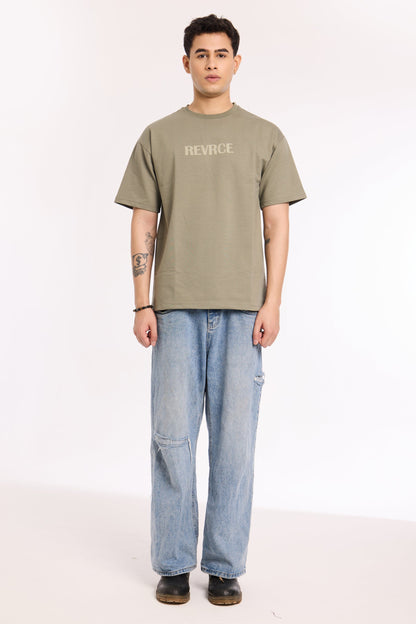 Back view of model wearing Cement by Revrce, oversized streetwear t-shirt