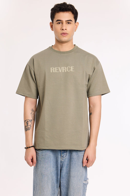 Model wearing Cement by Revrce, oversized fit streetwear T-shirt with front graphic