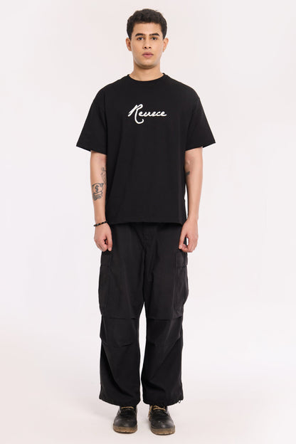 Model wearing Pretty Good T Shirt by Revrce, oversized fit streetwear T-shirt with front graphic