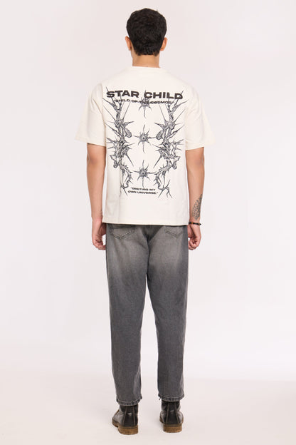 Close-up of Star Child T Shirt by Revrce showing puff print or fabric texture