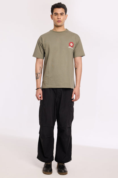 Model wearing Olive Beyond Time T Shirt by Revrce, oversized fit streetwear T-shirt with front graphic
