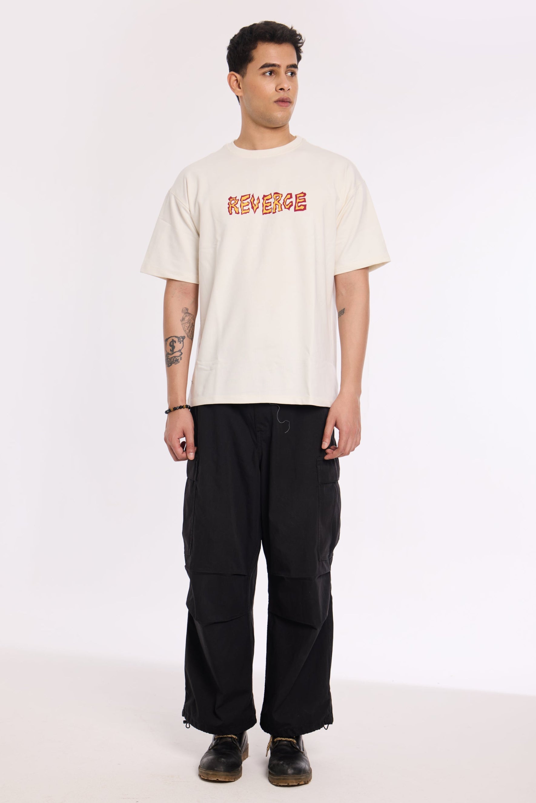 Model wearing Fired Up White T Shirt by Revrce, oversized fit streetwear T-shirt with front graphic