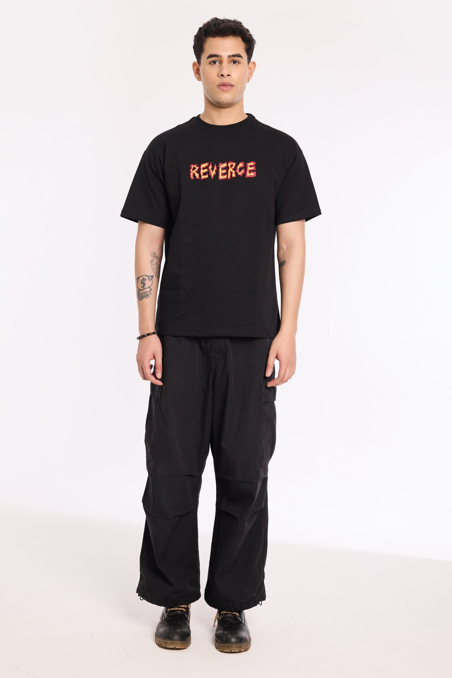 Model wearing Fired Up Black T Shirt by Revrce, oversized fit streetwear T-shirt with front graphic
