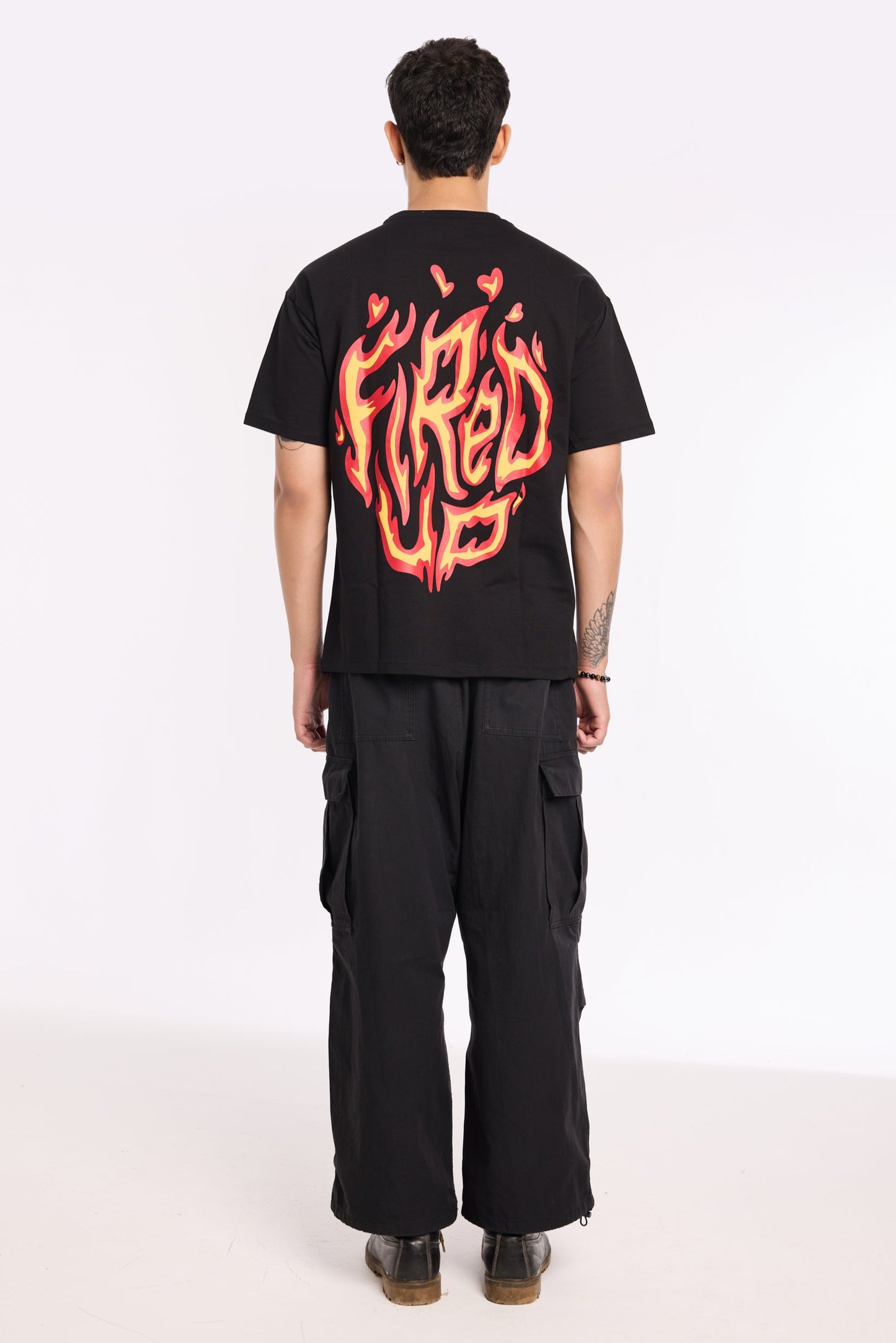 Flat lay of Fired Up Black T Shirt by Revrce, oversized streetwear t-shirt in detail