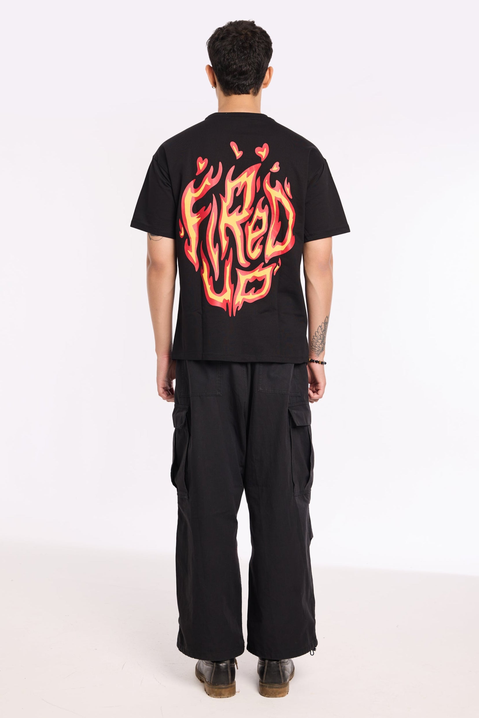 Flat lay of Fired Up Black T Shirt by Revrce, oversized streetwear t-shirt in detail